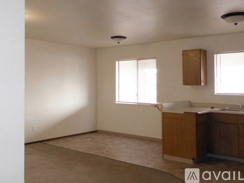 A room with wooden flooring and a white door.
