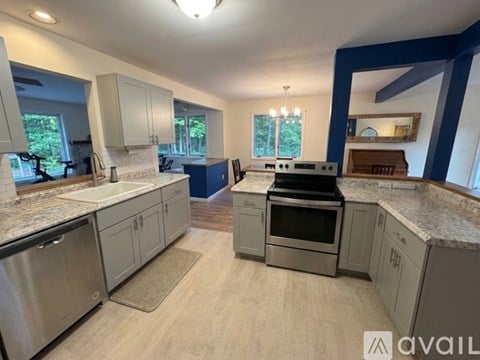 A kitchen with a large island and stainless steel appliances.