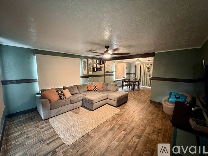 A living room with a couch and a rug.