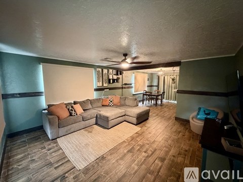 A living room with a couch and a rug.