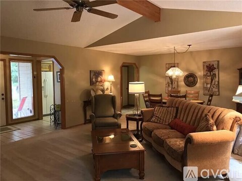 A living room with a couch, armchair, and coffee table.