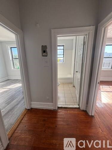 A room with wooden floors and white walls.