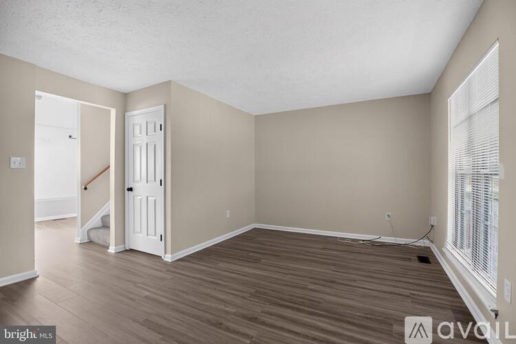 A room with wooden floors and a white door.