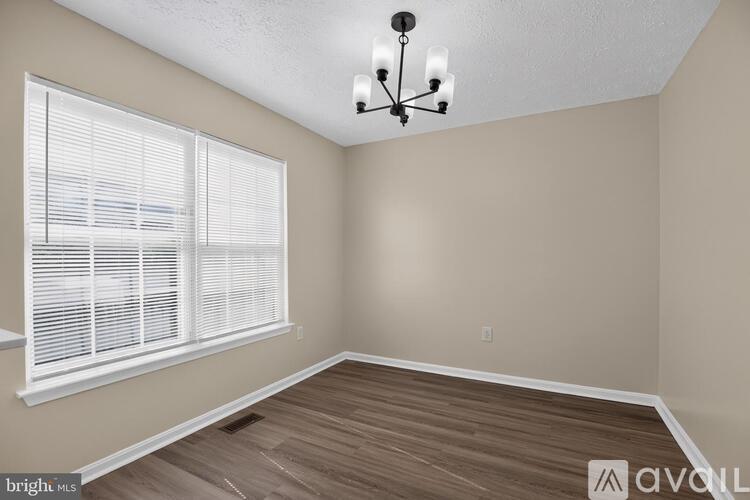 A room with a window and a chandelier.