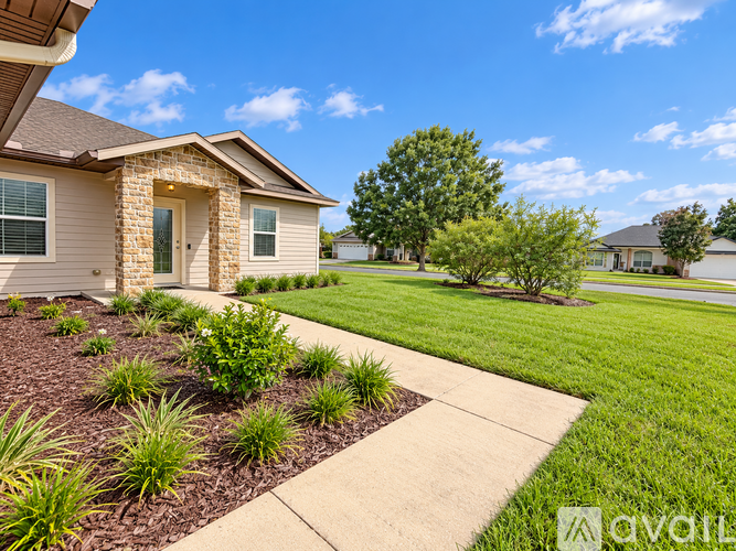 A house with a well-maintained lawn and a clear sky.