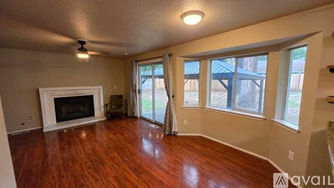 A living room with a fireplace and sliding glass doors.