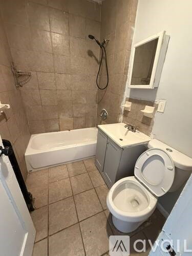 A small bathroom with a toilet, sink, and bathtub.