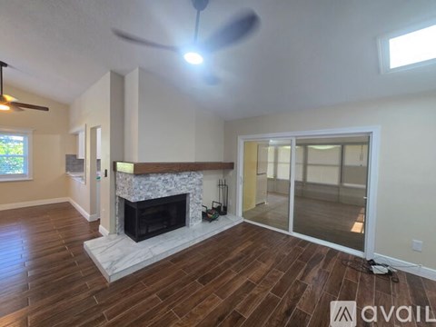 A living room with a fireplace and sliding glass doors.