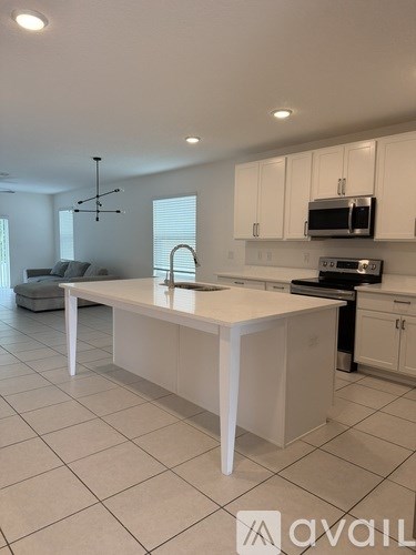 A kitchen with a white island in the middle.