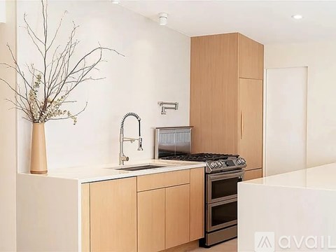 A kitchen with a white countertop and a brown cabinet.