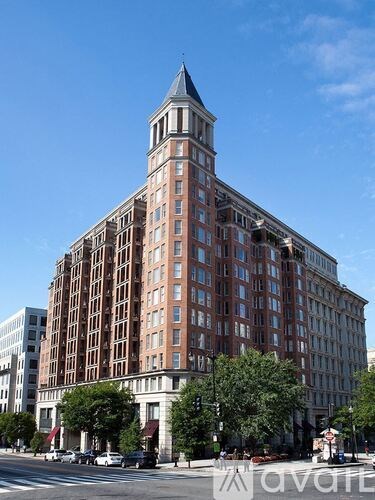 A large red brick building with a tower on the corner.