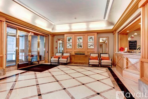 A spacious living room with a checkered floor and wooden furniture.