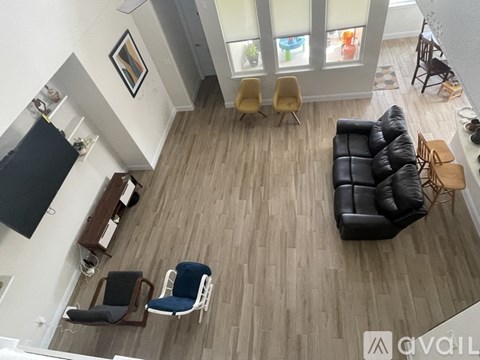 A living room with a black couch and a television.