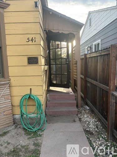 A yellow house with the number 541 on it.