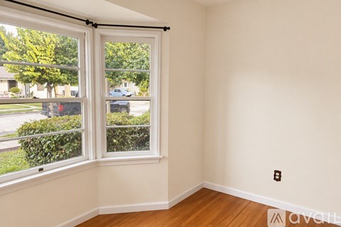 A room with a window overlooking a street.
