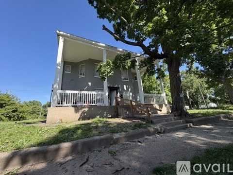 A house with a tree in front of it.