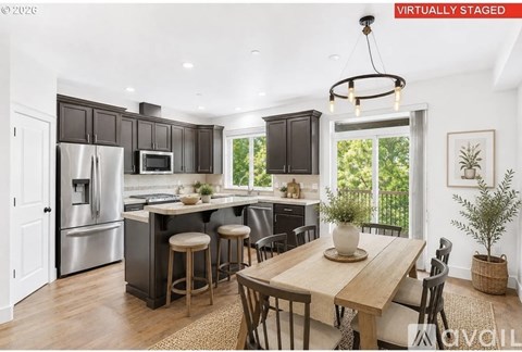 A modern kitchen with a dining table and chairs.