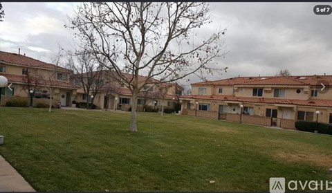 A grassy area in front of apartment buildings.