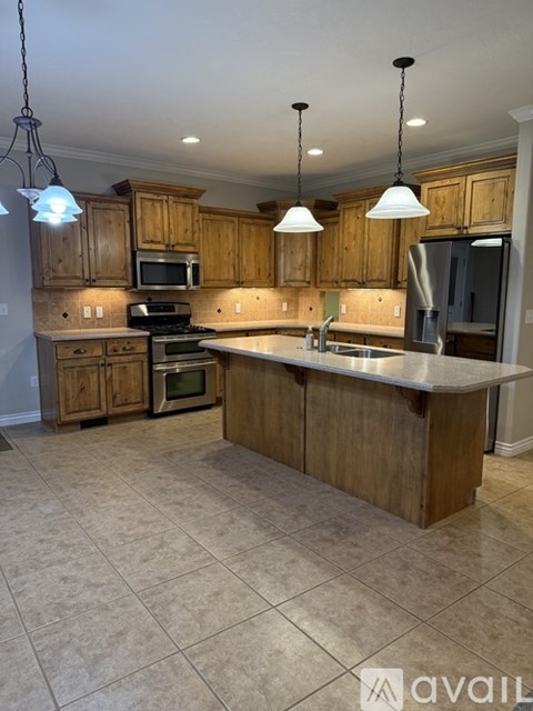 A kitchen with wooden cabinets and a central island.