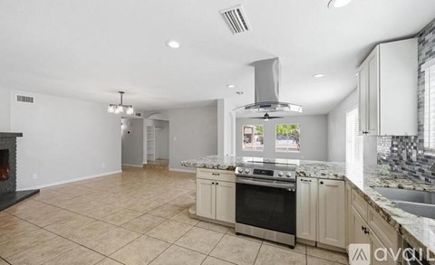 A kitchen with a stove top oven and a range hood.