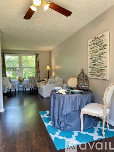 A dining room with a blue tablecloth and a white chair.