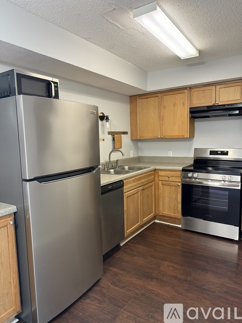 A kitchen with a stainless steel refrigerator and oven.