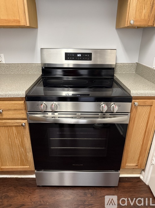 A modern stainless steel oven with a digital display and control panel.