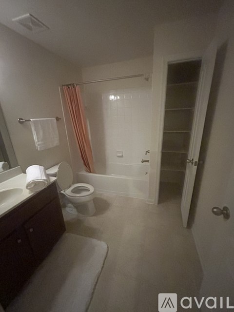 A bathroom with a toilet, sink, and shower.
