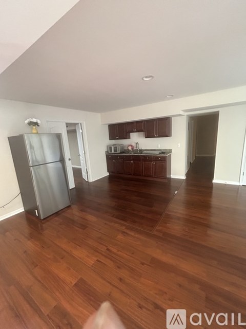 A kitchen area with a refrigerator and a sink.