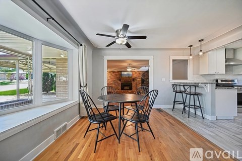 A dining room with a table and chairs is available for rent.