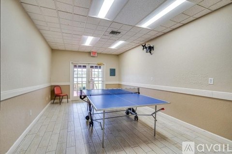 A room with a blue table and a red chair.