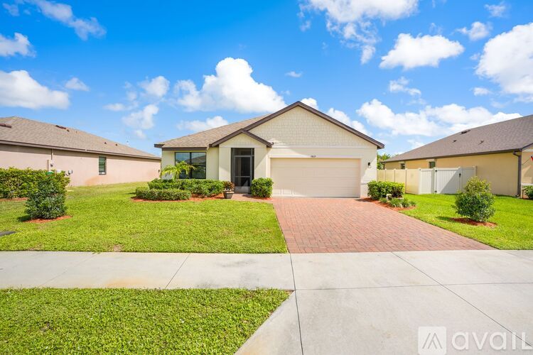 A house with a driveway in front of it is for sale.