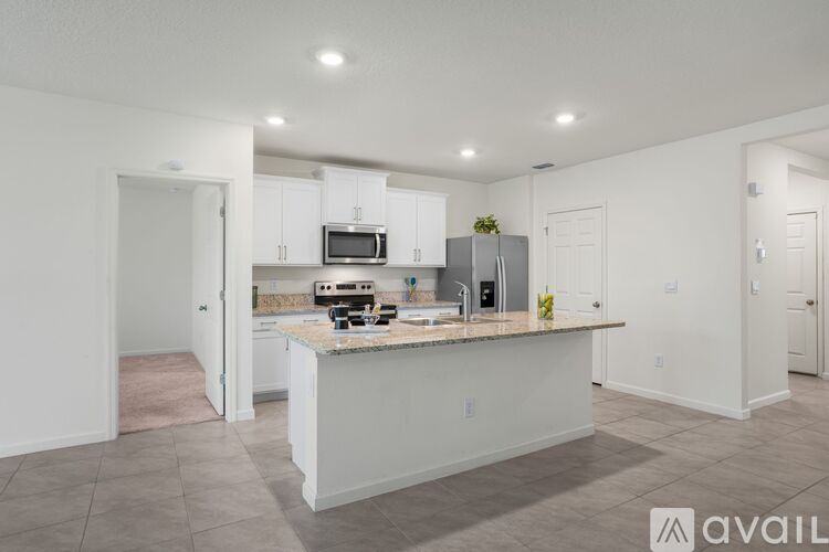 A kitchen with a countertop and cabinets is available for rent.