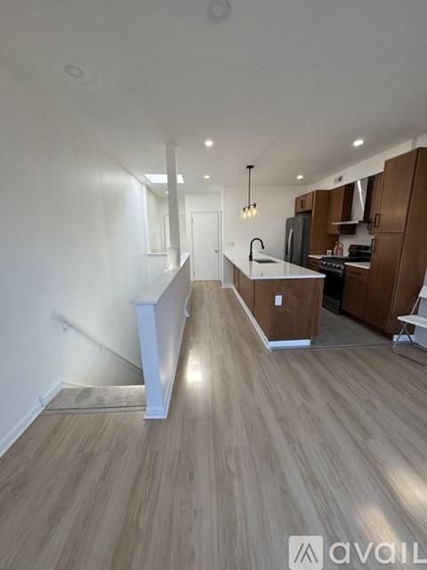 A kitchen with wooden cabinets and a white countertop.