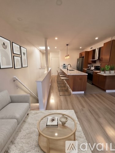 A modern living room with a grey sofa and a wooden coffee table.
