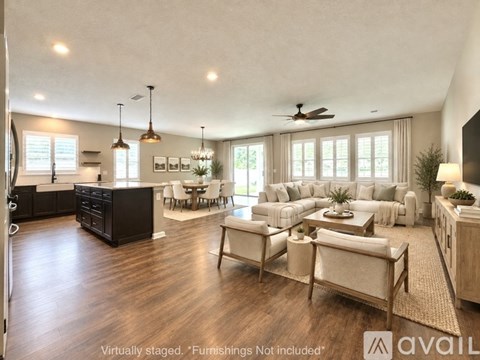 A living room with a black cabinet, white couches, and a rug.