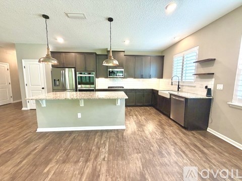 A kitchen with a white island in the middle of the room.