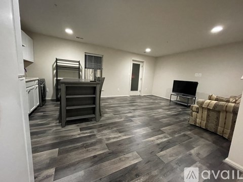 A living room with a grey sofa and a television set.