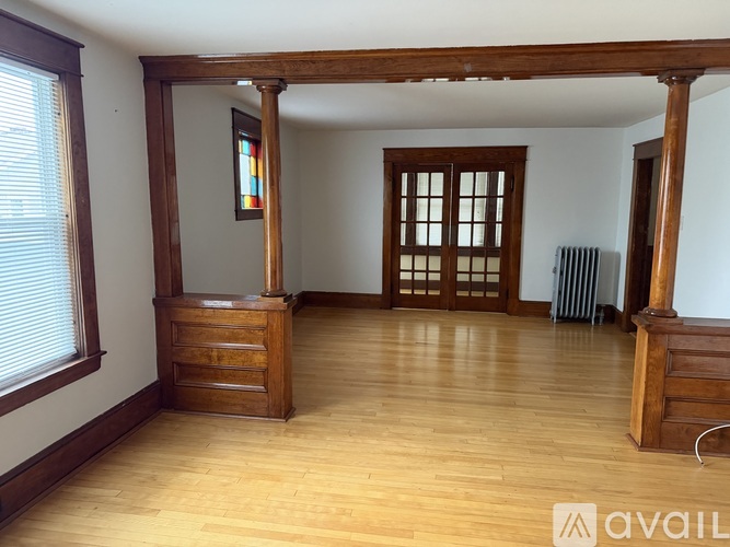 A room with wooden floors and a large window.