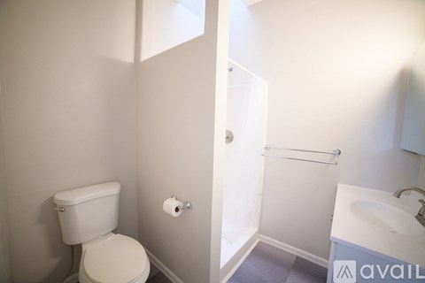 A bathroom with a toilet, sink, and bathtub.