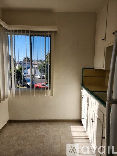 A room with a window showing a street view.