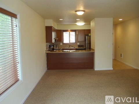 A kitchen area with brown cabinets and a countertop.