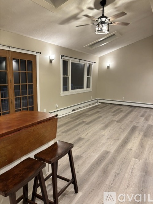 A room with a wooden bar and stools.