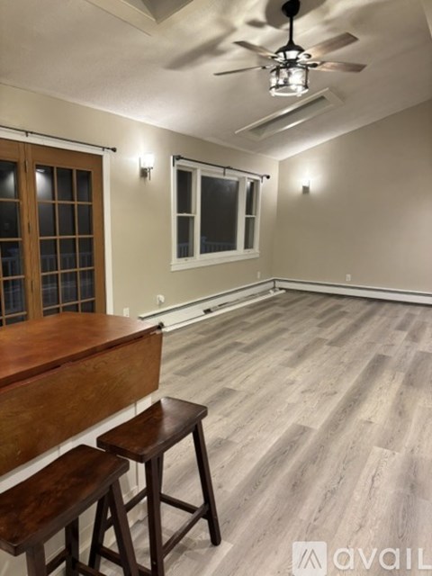 A room with a wooden bar and stools.