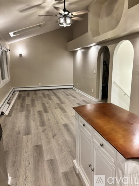 A room with a wooden floor and a brown countertop.