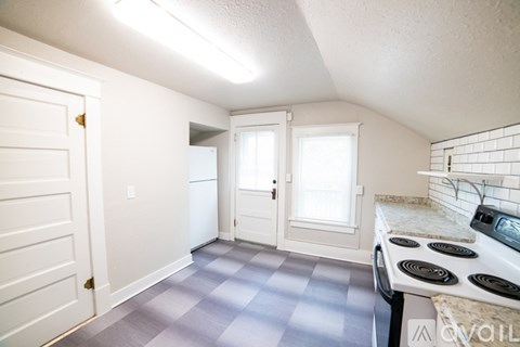 A kitchen with a stove, oven, and cabinets.