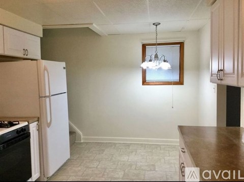 A kitchen with a white refrigerator and a wooden counter.