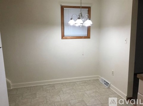 A room with a window and a tiled floor.