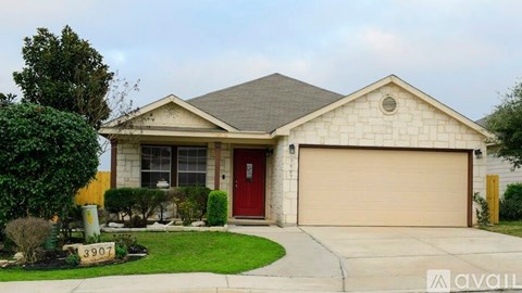 A house with a red door and a garage door is for sale.
