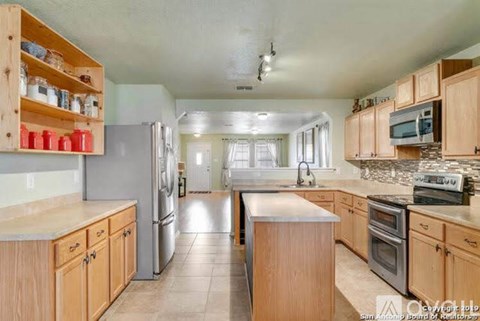 A kitchen with wooden cabinets and stainless steel appliances.